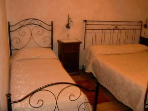 a bedroom with two beds and a nightstand at Agriturismo Masseria Castiglione in Gallicchio