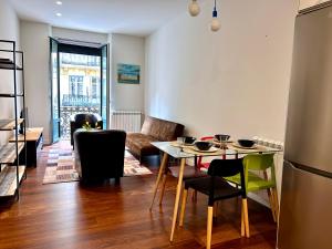 een keuken en woonkamer met een tafel en stoelen bij Larramendi City Center in San Sebastian