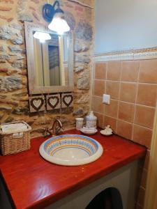 a bathroom with a sink and a mirror at Large Stone Villa with garden. in Khánia