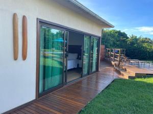 a house with a deck with sliding glass doors at Pousada Lua Bela in Fernando de Noronha