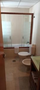 a bathroom with a toilet and a sink and a mirror at Habitación doble independiente con baño compartido in Granada