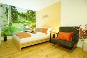 a bedroom with a bed and a chair and a window at RELAX - ORANGE mit Pool und Sauna in Sonthofen