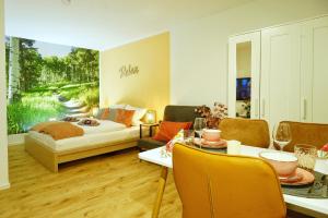 a living room with a couch and a table at RELAX - ORANGE mit Pool und Sauna in Sonthofen