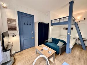 - un salon avec des lits superposés et un canapé bleu dans l'établissement Le Piccolo, Centre-ville, à Bordeaux