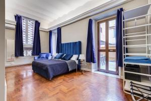 a bedroom with blue curtains and a bed in a room at SPANISH GARDEN in Rome
