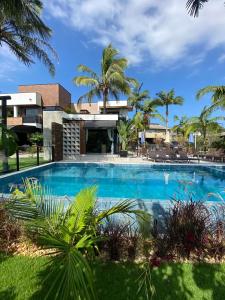 a large swimming pool in front of a resort at Pousada Bella Casa in Balneário Camboriú