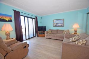 a living room with two couches and a tv at Bay Princess 211 in Ocean City