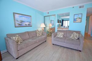 a living room with two couches and blue walls at Bay Princess 211 in Ocean City