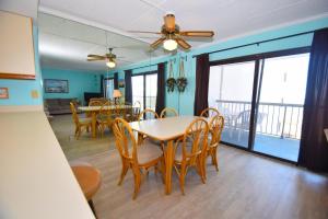 a dining room and living room with a table and chairs at Bay Princess 211 in Ocean City