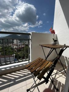 a wooden chair sitting on a balcony with a table at Sun Executive Suite Entire Unit @Bayan Lepas #5pax #Queensbay #SPICE #100Mbps in Bayan Lepas