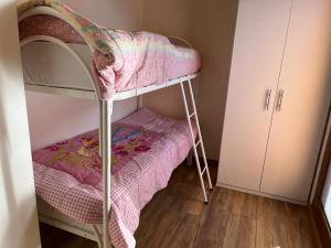 a little girls bunk bed in a room at Perla Top Floor Apartment in Sirmione