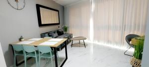 a living room with a table and chairs and a couch at beach front tel aviv bat yam apartment -hotel 39 in Bat Yam