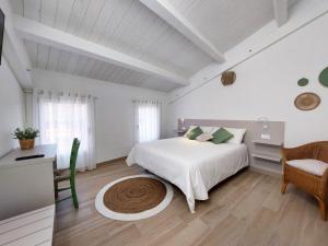 a white bedroom with a white bed and a desk at Affittacamere Casa Lilibet in San Benedetto del Tronto