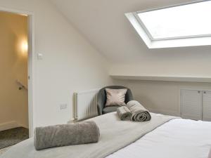 a bedroom with a large bed with a skylight at Moat View in Brampton