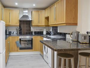 a kitchen with wooden cabinets and a counter top at Moat View in Brampton