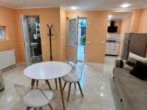 a living room with a table and chairs and a couch at RENATO in Tbilisi City