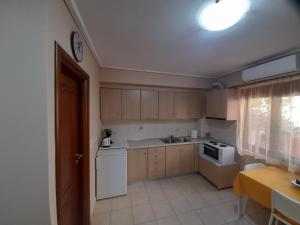 a small kitchen with a sink and a microwave at Nikos Studio in Kalyves