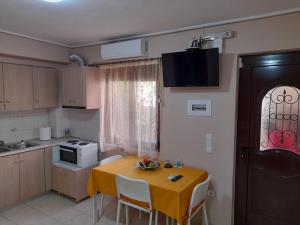 a kitchen with a table with a yellow table cloth on it at Nikos Studio in Kalyves
