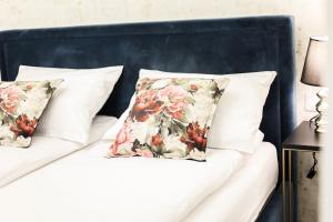 2 almohadas blancas en una cama con cabecero azul en CracWoW Saint Sebastian Apartments, en Cracovia