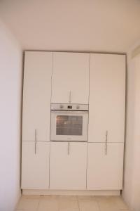 a kitchen with white cabinets and an oven at Casa Vacanze L’Ulivo in Salerno