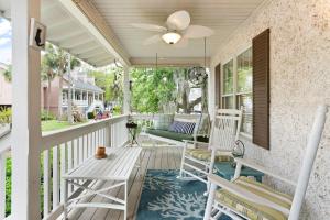 a porch with two chairs and a ceiling fan at Village Walk - 104 Mews Circle in King City