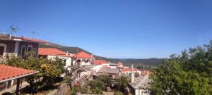 a view of a town with mountains in the background at Rising Sun Guesthouse in Mesokhória