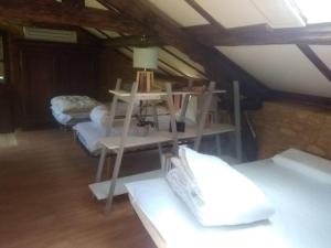 Zimmer mit 2 Betten und einem Tisch mit einer Lampe in der Unterkunft Petite maison de caractère in Le Bousquet