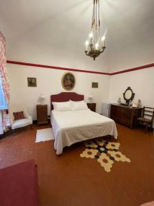 a bedroom with a bed and a chandelier at Bed & Breakfast Scià Dina in Toirano