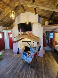 a living room with a stone fireplace with a chair at Tiernan's Luxury Cottages in Newtown-Dillon