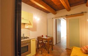 a small kitchen with a table and a stove at Gorgeous Apartment In Fano With Wifi in Fano