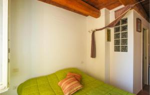 a green bed in a room with a window at Gorgeous Apartment In Fano With Wifi in Fano