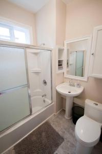 a bathroom with a toilet and a shower and a sink at Heritage Townhouse in Downtown Halifax in Halifax