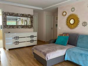 sypialnia z kanapą, komodą i lustrem w obiekcie Cagnes-sur-Mer, 50m de la mer, au calme w Cagnes-sur-Mer
