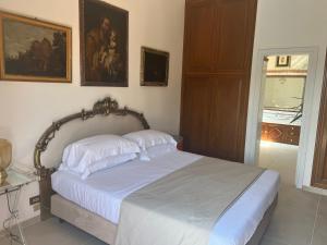 a bedroom with a bed with two pillows on it at Domus Orestea Luxury Suites in Palermo