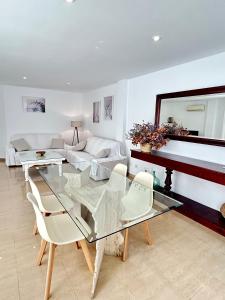 a living room with a glass table and chairs at Villa Teresa in Colonia Sant Jordi
