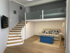a living room with a loft bed and a couch at Lux Apartment Studio in Berehove