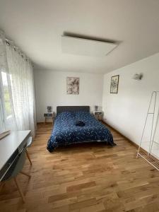 a bedroom with a bed and a desk in it at les jardins d'Holly in Avesnes-en-Bray