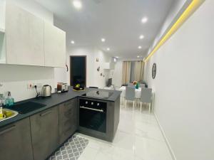 a kitchen with a sink and a counter top at Central Modern Apartment Msida in Msida