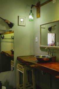 a bathroom with a sink and a mirror at Recanto de Encantos in Campos do Jordão
