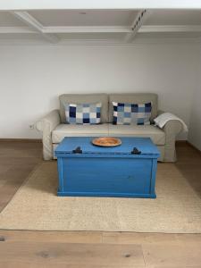 a blue coffee table in a living room with a couch at Lux Apartment Studio in Berehove