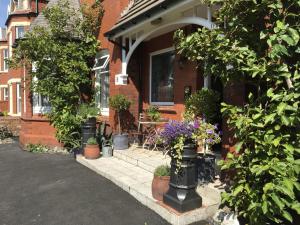 a house with potted plants in front of it at The Old School House in Lytham St Annes