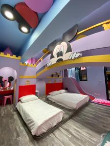 a bedroom with two beds in a mickey mouse room at 高雄親子溜滑梯High Fun旅店 in Kaohsiung