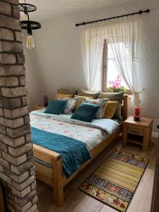 a bed in a room with a brick wall at Sielska Dolina Czarny Łabędź in Gniewino