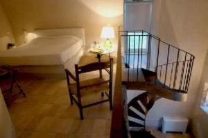 a small room with a bed and a stair case at Residence Posillipo in Naples