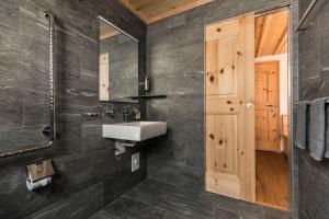 a bathroom with a sink and a mirror at Casa LA RODA in Sedrun