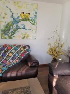 a living room with a couch and a painting on the wall at Your home in Colorado Springs in Colorado Springs