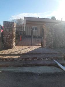 a gate to a house with a stone fence at Your home in Colorado Springs in Colorado Springs