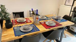 einem Holztisch mit Tellern und Geschirr darauf in der Unterkunft Sonnenlay Lounge - Studio & Ferienhaus in Brauneberg