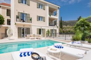 a villa with a swimming pool and a building at Villa Mirta in Bol