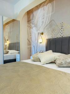 a bedroom with a bed and a wall with feathers at Villa Sun in Čilipi